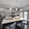 Spacious and well lit kitchen with wood flooring and stainless steel appliances