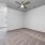 Large well lit bedroom with plush carpets and large windows 