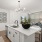 Spacious and well lit kitchen with wood flooring and open access to the living room