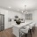 Spacious and well lit kitchen with wood flooring and stainless steel appliances