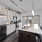 Spacious and well lit kitchen with wood flooring and stainless steel appliances