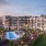 Large sparkling blue pool with a large pool deck and lounge chairs