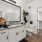 Large well lit bathroom with white accents 