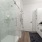 Large well lit bathroom with white accents 