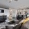 Spacious and well lit living room with wood flooring, large windows and open access to the kitchen