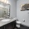 Large well lit bathroom with white accents 