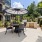table with chairs and an umbrella by pool