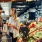 a man and a woman shopping at a grocery store